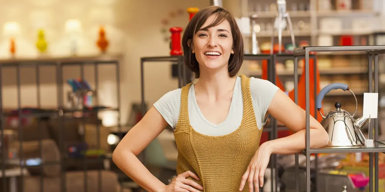 Small business owner smiling in her shop